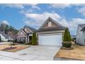 Traditional home with a two car garage, landscaping and long driveway at 103 Tanoak Ct, Durham, NC 27703