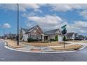 Attractive home with stone and siding, manicured landscaping, and a welcoming front porch on corner lot at 103 Tanoak Ct, Durham, NC 27703