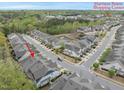 An aerial view of the home in a community that features mature trees, landscaping, and a shopping center nearby at 111 Wards Ridge Dr, Cary, NC 27513
