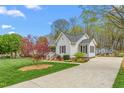 Charming single story home with a well-maintained lawn, inviting porch, attractive landscaping and driveway at 124 Holly Ridge Ln, Mebane, NC 27302