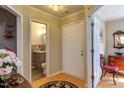 Hallway with hardwood floors and a door to a bathroom with a gray vanity at 125 Long Shadow Pl, Durham, NC 27713