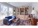Living room with built-in bookshelves, a blue sofa, and lots of natural light at 125 Long Shadow Pl, Durham, NC 27713