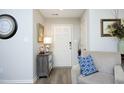 Inviting entryway with wood-look floors, neutral walls, accent furniture, and decor at 127 Hurricane Aly, Benson, NC 27504