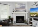 Fireplace with a white mantle, decorative decor, and a mounted television at 127 Hurricane Aly, Benson, NC 27504