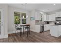Breakfast nook with modern lighting and a view, adjacent to kitchen with granite countertops at 128 School Side Dr, Spring Lake, NC 28390