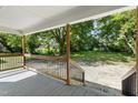 Spacious covered back porch featuring a wooden railing, offering a relaxing outdoor space at 129 Burwell Avenue Ave, Henderson, NC 27536
