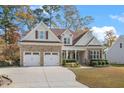 Charming two-story home featuring brick and siding, a two-car garage, and manicured landscaping at 1312 Golden Bluff Ln, Fuquay Varina, NC 27526