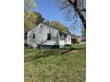 Side view of a home featuring vinyl siding and a yard at 141 N Bullock St, Henderson, NC 27536