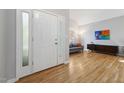 Light-filled foyer with hardwood floors that flow into a living room and showcase the home's open layout at 1550 Pathway Dr, Carrboro, NC 27510