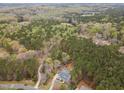 Expansive aerial view showing the property surrounded by mature trees and lush greenery, providing privacy at 160 Sweet Pine Cir, Pittsboro, NC 27312