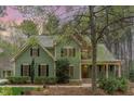 Charming two-story home boasts lush landscaping, a welcoming front porch, and a well-maintained green lawn at 160 Sweet Pine Cir, Pittsboro, NC 27312