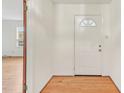 Welcoming entryway with hardwood flooring and a classic white front door at 209 High House Rd, Cary, NC 27513