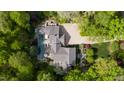 Overhead view of an estate with a swimming pool, gardens, and stone driveway surrounded by mature trees at 2105 White Oak Rd, Raleigh, NC 27608