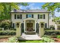Stately brick home featuring a water feature, gated entrance and professionally landscaped front yard at 2105 White Oak Rd, Raleigh, NC 27608