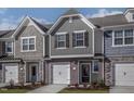 Beautifully designed townhome exterior with varied siding, stone accents, and attached garages at 2114 Willow Gln Dr, Graham, NC 27253