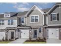 Charming townhome featuring a stone and shingle facade, attached garages, and neatly landscaped front yards at 2118 Willow Gln Dr, Graham, NC 27253