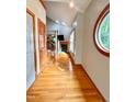 Inviting entryway with hardwood floors, arched window, and a view into the living room at 212 Columbia W Pl, Chapel Hill, NC 27516