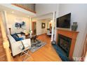 Bright living room features hardwood floors, a fireplace, and comfortable seating at 212 Columbia W Pl, Chapel Hill, NC 27516