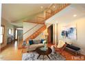 Cozy living area with hardwood floors, a staircase, and ample natural light at 212 Columbia W Pl, Chapel Hill, NC 27516