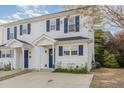 Well-maintained townhouse with white siding, blue shutters, and a neatly landscaped front garden at 2225 Whistling Straits Way, Raleigh, NC 27604