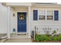 Charming front entry with a navy door, decorative wreath, manicured garden, and inviting curb appeal at 2225 Whistling Straits Way, Raleigh, NC 27604