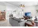 Cozy living room with neutral paint, plush gray sofas and bright, natural light at 2400 Perennial St, Raleigh, NC 27603