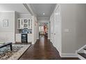Hallway view of home's dry bar with wine cooler, hardwood floors and neutral walls creating a welcoming atmosphere at 2713 Tunstall Grove Dr, Apex, NC 27523