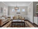 A cozy living room is decorated with comfortable furnishings, natural light, and an eye-catching rug at 2713 Tunstall Grove Dr, Apex, NC 27523