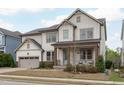 Charming two-story home with a covered front porch and an attached two-car garage at 288 Whispering Wind Dr, Chapel Hill, NC 27516