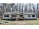 Inviting single-story home with a charming covered porch and well-kept landscaping, perfect for a cozy retreat at 3014 Split Wood Ct, Oxford, NC 27565