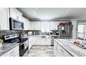 Modern kitchen with white cabinets, stainless steel appliances, and a stylish island at 3014 Split Wood Ct, Oxford, NC 27565