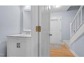 Bright powder room with decorative mirror, fixtures, and marble countertop at 302 Rushingwater Dr, Cary, NC 27513