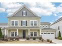 Charming two-story home with an attached garage, covered porch, and beautifully landscaped front yard at 3348 Table Mountain Pine Dr, Raleigh, NC 27616