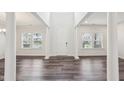 Bright foyer with soaring ceilings, elegant columns, and wood-look flooring at 3348 Table Mountain Pine Dr, Raleigh, NC 27616