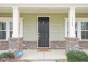 Inviting front door with decorative brick accents and a charming welcome mat at 3348 Table Mountain Pine Dr, Raleigh, NC 27616