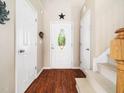 Inviting entryway featuring hardwood floors, a decorative light fixture, and ample natural light at 3690 Mabel Ln, Stem, NC 27581