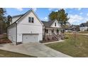 Charming two-story home with a white exterior, two-car garage and landscaped front yard at 381 Heart Pine Dr, Wendell, NC 27591