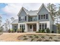 Charming exterior view of a home featuring gray siding, stone accents and well-manicured landscaping at 3908 Sage Ct, Wake Forest, NC 27587