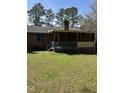 View of screened-in back porch with wooden railings and lattice detail at 4001 W Antioch Dr, Oxford, NC 27565