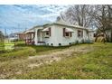 Back view of home featuring white siding, red and white awnings and a modest yard at 415 Estell St, Rocky Mount, NC 27803