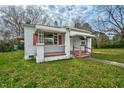 Side view of home featuring white siding, covered porch, and red and white awnings at 415 Estell St, Rocky Mount, NC 27803