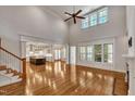 Bright and airy living room with hardwood floors, soaring ceilings, and an open floor plan into the kitchen at 45 Calabria Ct, Clayton, NC 27527