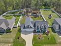 Aerial view of a home featuring a spacious yard, fenced play area, and long driveway at 49 Everwood Dr, Four Oaks, NC 27524