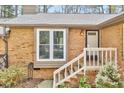 Brick exterior with steps and white painted railings to the front door at 500 W Woodcroft Pkwy, Durham, NC 27713