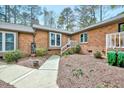 Brick exterior with steps and white painted railings to the front door at 500 W Woodcroft Pkwy, Durham, NC 27713