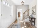 Bright foyer with hardwood floors, staircase, and classic decor at 504 W Brocklyn St, Benson, NC 27504