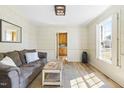 Sunlit living room boasts hardwood floors, modern lighting, and cozy, neutral decor at 504 W Brocklyn St, Benson, NC 27504