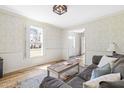 Inviting living room with hardwood floors, neutral decor, and ample natural light at 504 W Brocklyn St, Benson, NC 27504