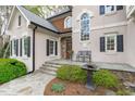 Inviting front entrance with a stone walkway, complemented by stylish windows and a bench seating area at 506 Rose Point Dr, Cary, NC 27518
