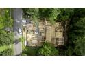 Aerial view of a home under construction with lumber and construction vehicles at 5205 Quail Meadows Dr, Raleigh, NC 27609